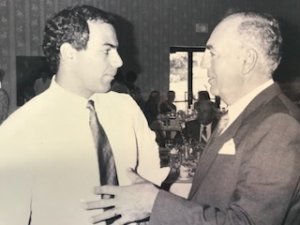 black and white photo of 2 men talking