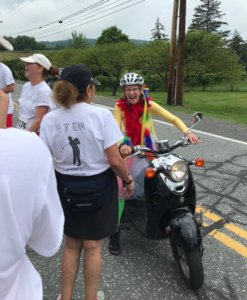 a women on a scooter talking to another women with her back to the camera