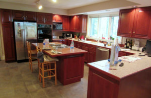 large kitchen with red-toned cabinets