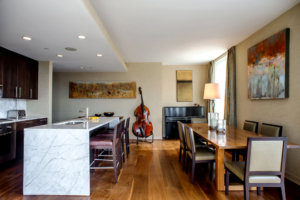 open concept kitchen and dining room with a stand up bass in the background