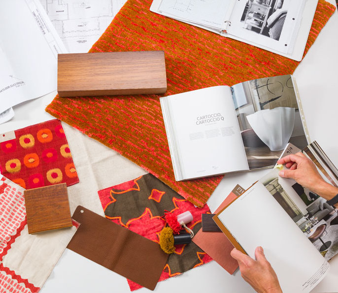 female interior designer working with plans and fabric samples, view from above