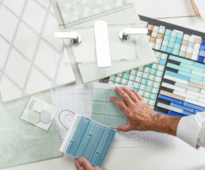 designer working with tile samples, view from above