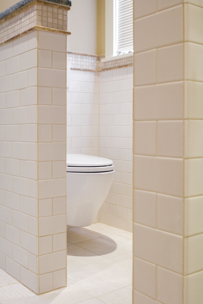 view of a modern looking toilet in a tile bathroom