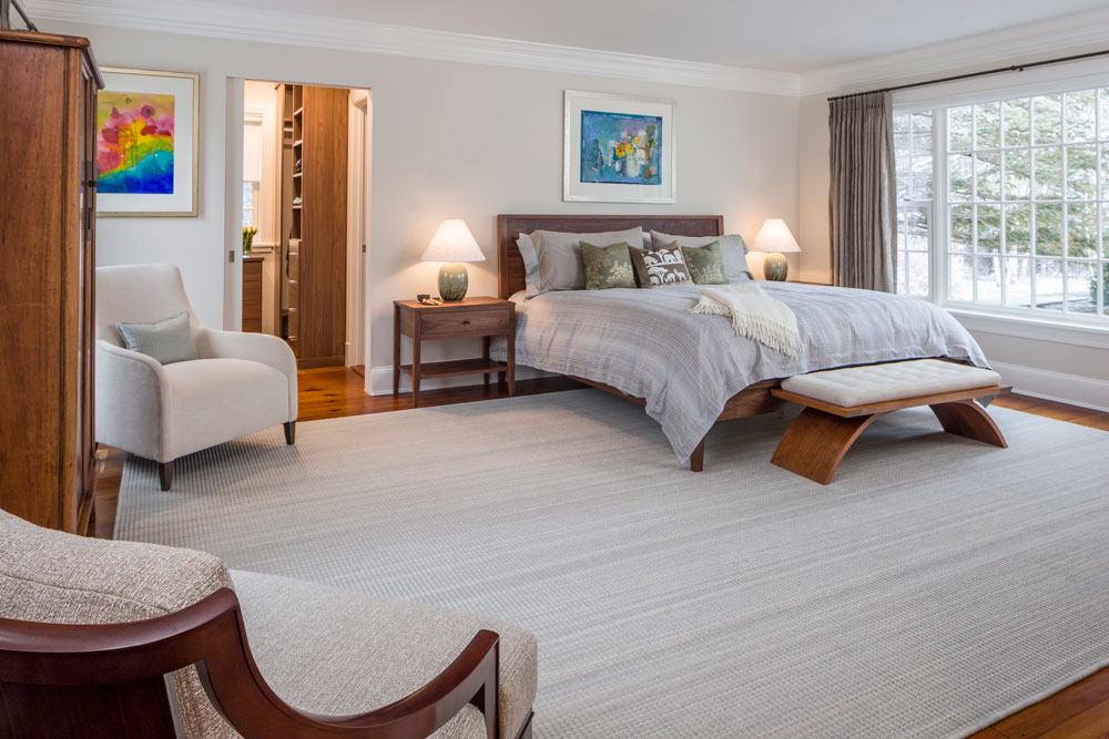 view of a master bedroom with a large white carpet and big bay window