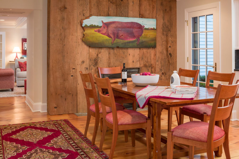 farmhouse dining room with a painting of a pig on the wall