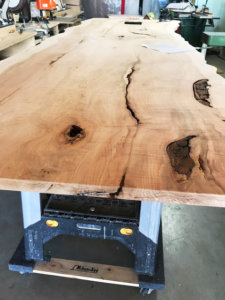 live edge wood slab on a workbench