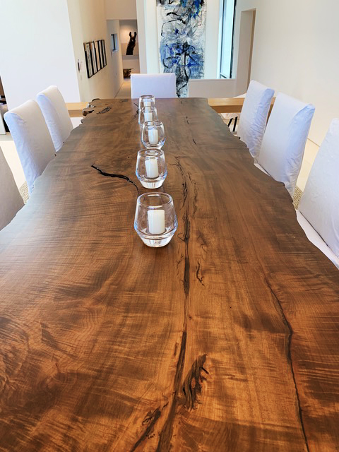 long live edge wooden table with candles lined up along the center line