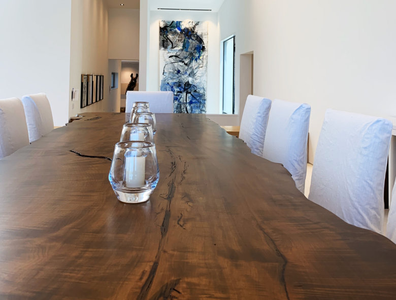 live edge wooden dining room table with glass votives